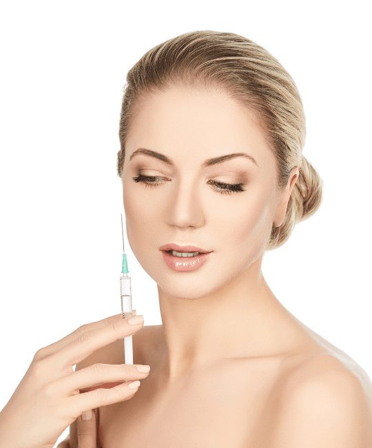 A woman holding a syringe near her face, eyes closed.
