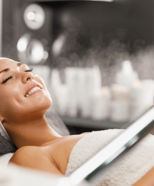 A woman relaxing with eyes closed, enjoying a spa treatment.
