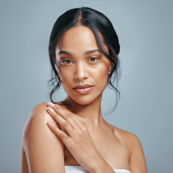 Portrait of a serene woman with flawless skin and natural makeup.