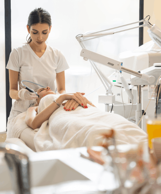 A woman receiving a facial treatment in a modern spa.