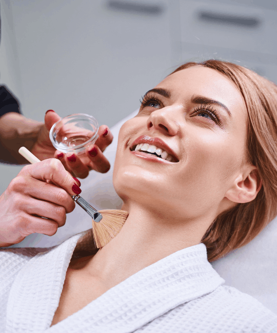 Woman enjoying a facial treatment with a serum application.