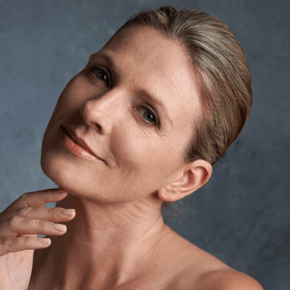 Portrait of a serene woman with a gentle smile and natural makeup.