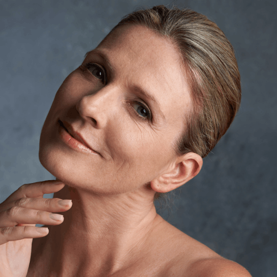 Portrait of a serene woman with a gentle smile and natural makeup.