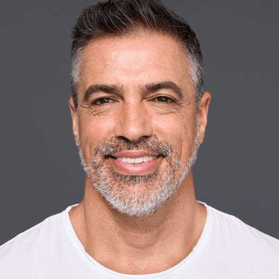 Smiling middle-aged man with salt-and-pepper hair and beard.