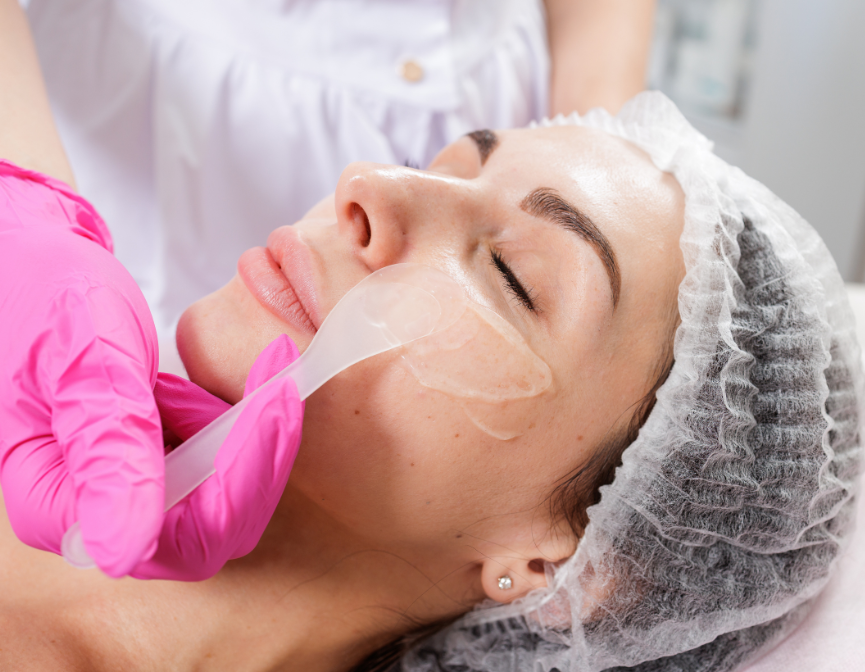 Woman receiving a gentle facial treatment at a spa.