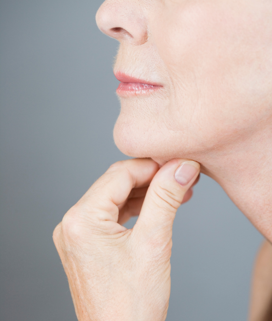 Close-up of a person touching their chin contemplatively.