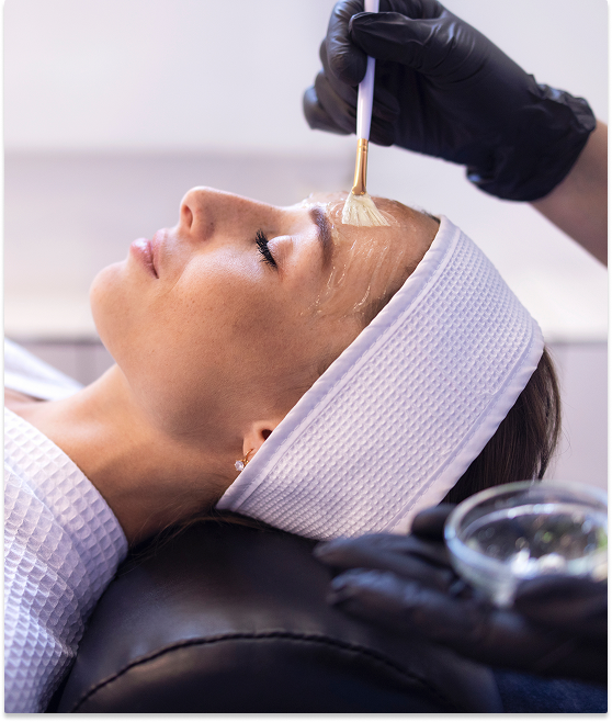 Woman receiving a facial treatment with a dropper in a spa.