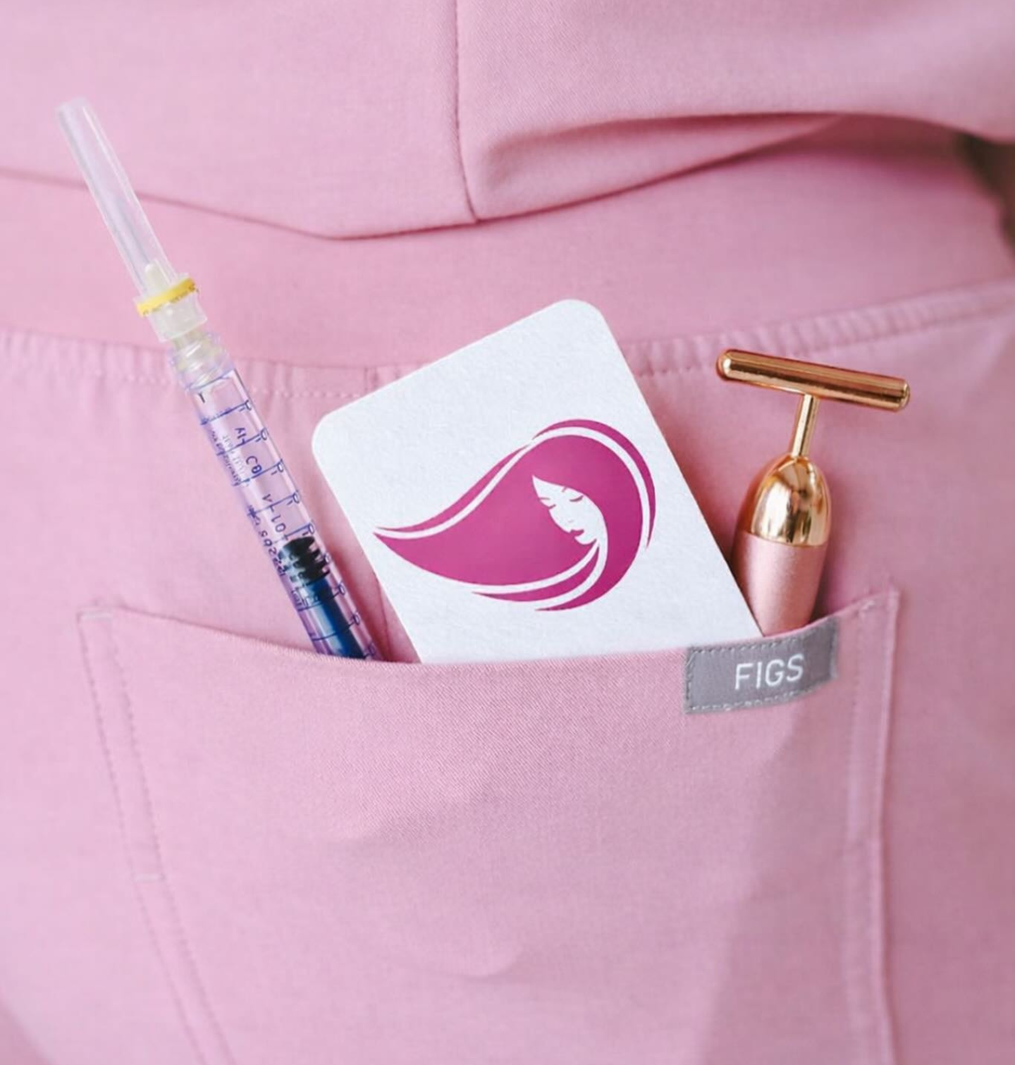 Medical syringe, beauty device, and card in pink pocket.